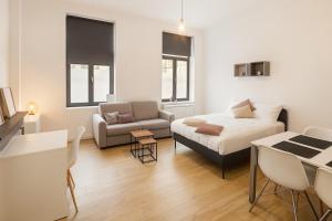 a living room with a bed and a couch at Toison d'Or Apartment in Brussels +2 photos