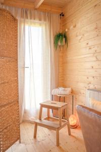 a wooden room with a table and a window at Taigh Scalpaigh in Portree