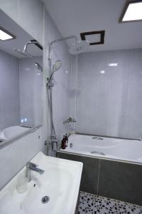 a bathroom with a tub and a sink and a bath tub at We House River View Hotel And Travel in Luang Prabang +26 photos