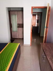 a room with a bed and a hallway with a bathroom at Rooms with WiFi, Parking - 3BHK Villa in Kodaikānāl