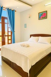 Ένα ή περισσότερα κρεβάτια σε δωμάτιο στο Green Ville Hotel Đồng Nai