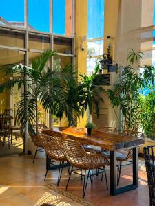 a table and chairs in a room with plants at Hotel Palacio Puerto Princesa in Puerto Princesa City +13 photos
