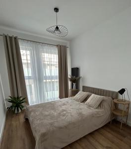 Ένα ή περισσότερα κρεβάτια σε δωμάτιο στο Apartament Parkowa-prywatny parking