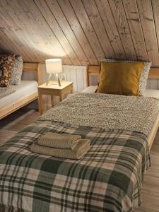 a bedroom with a bed and a table with a lamp at Ubytovanie Hronec in Hronec