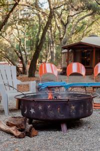a fire pit with chairs and a table and chairs at Tranquil Yurt Rental for Two with Soothing Interior on Ranch near San Luis Obispo in Cayucos