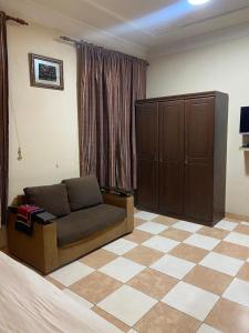 a living room with a couch and a checkered floor at أللورا زون - Alora Zone in Abha