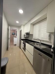a kitchen with a sink and a counter top at Casa Miriam Family Lux in Oropesa del Mar