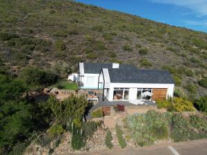 an aerial view of a house on a hill at Fish Eagle House on the Dam in Montagu