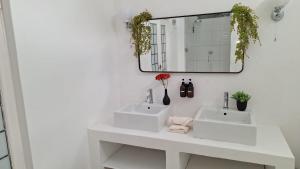 a bathroom with two sinks and a mirror at Karoo Sunset Villa in Richmond +12 photos
