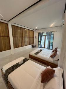 a bedroom with two beds and a large window at Cam u view Guest House in Nongkhiaw +42 photos