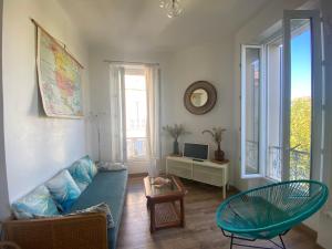 a living room with a couch and a table at CASA BLUE sur une jolie place proche du vieux port by LaConciergerie13 in La Ciotat
