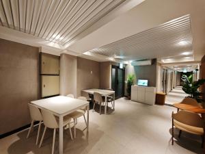 a restaurant with tables and chairs in a room at Unit D Hostel in Seoul