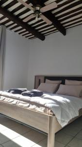 a bed in a white room with a ceiling at Stéphanie in Remoulins