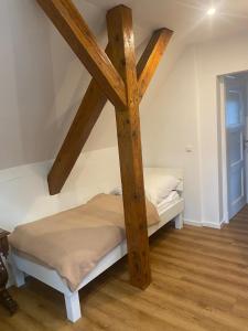 two beds in a room with wooden beams at Gästewohnung Augsburg - Spickel in Augsburg