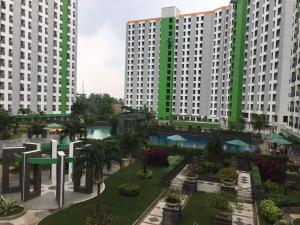 a view of two large white buildings with green at Bram Rooms Green Lake View Ciputat in Pondokcabe Hilir