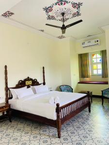 a bedroom with a large bed and a ceiling at Aryavarta A Boutique Abode in Nāi