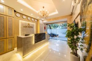 a lobby of a akoya hotel with a potted plant at A25 Hotel - 75 Lê Thị Hồng Gấm in Ho Chi Minh City +31 photos