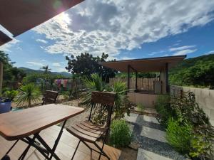 a wooden table and chairs on a patio at Cây Trôm Homestay 1 in Vĩnh Hy