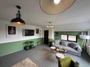 a living room with a couch and a table at Vitamine Central Apartment in Craiova