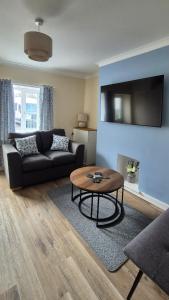 a living room with a couch and a coffee table at Amaryllis Escapes in Brecon