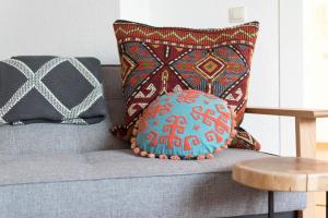 a blue pillow sitting on a couch with a table at Modern design im klassischem Altbau in Weimar