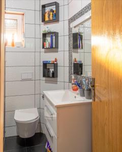 a bathroom with a white sink and a toilet at Vienna Rem in Lukavac +32 photos