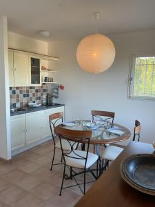 a kitchen and dining room with a table and chairs at Bellevue 2 in La Boissière
