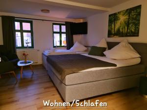 a bedroom with two beds and two windows at Apartment Marktplatz in Kaxdorf