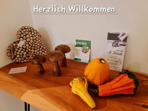 a wooden table with mushrooms and vegetables on it at Apartment Marktplatz in Kaxdorf