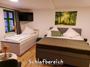 a bedroom with a bed and a couch at Apartment Marktplatz in Kaxdorf