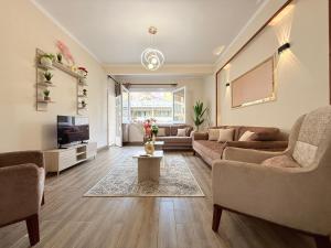 a living room with two couches and a tv at Moonlight Homes Tahrir Square in Cairo