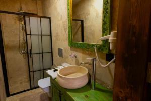 a bathroom with a sink with a toilet and a mirror at Gemosa Cappadocia Hotel in Urgup +95 photos