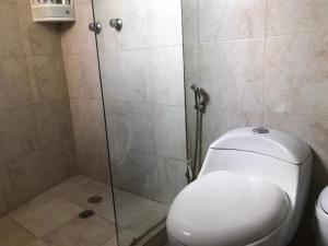 a bathroom with a toilet and a glass shower at Apartmento Minutos Caracola Beach in Porlamar +4 photos