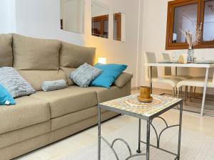 ein Wohnzimmer mit Sofa und Tisch in der Unterkunft El Valle Golf Resort in Baños y Mendigo