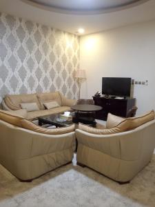 a living room with two couches and a table at فندق مرايا بارك in Najran