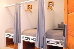 a bedroom with two bunk beds and a mirror at Tipsea Turtle Gili Trawangan in Gili Trawangan