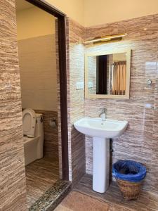 a bathroom with a sink and a toilet at Sherpa Hills in Kathmandu