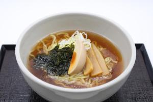 a bowl of noodle soup with bananas and other ingredients at Dormy Inn Premium Sapporo in Sapporo