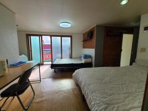 a bedroom with a bed and a desk and a table at A total of 4 people on one floor of a building close to Incheon Airport that can be used for a short period of time in Seoul