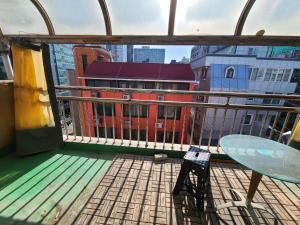 a balcony with a view of a red building at A total of 4 people on one floor of a building close to Incheon Airport that can be used for a short period of time in Seoul