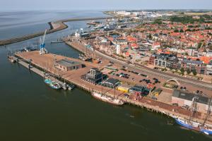 an aerial view of a harbor with boats in the water at Slapen in een Trechter in Harlingen