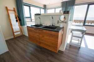 a bathroom with a sink and a counter with a view of the ocean at Slapen in een Trechter in Harlingen +13 photos