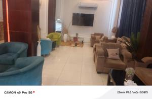 a living room with couches and a flat screen tv at رندة المدن للشقق المخدومة in Jazan