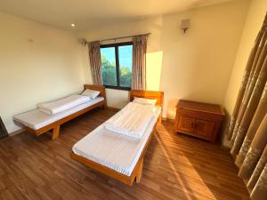 a room with two beds and a window at Sherpa Hills in Kathmandu +12 photos