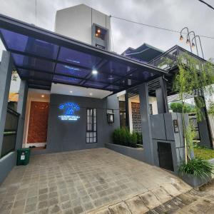 a house with a blue roof at Villa Yo and By in Karangploso +13 photos