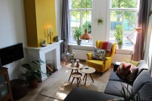 a living room with a couch and a table at The Cozy Nest in Arnhem