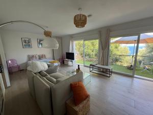 a living room with a couch and a table and a tv at Villa Pietranera in San-Martino-di-Lota