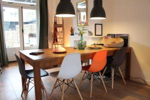 a kitchen with a wooden table with four chairs at The Cozy Nest in Arnhem