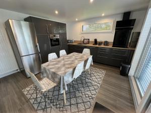 a kitchen with a table and chairs and a refrigerator at Chez Eliane in Bennwihr