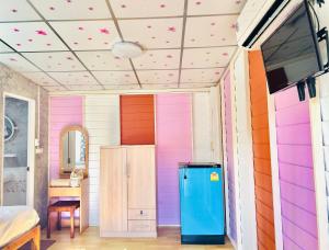 プラナコーン・シー・アユタヤにあるHome one love Ayutthaya bangalow zoneのカラフルな壁と冷蔵庫のある部屋